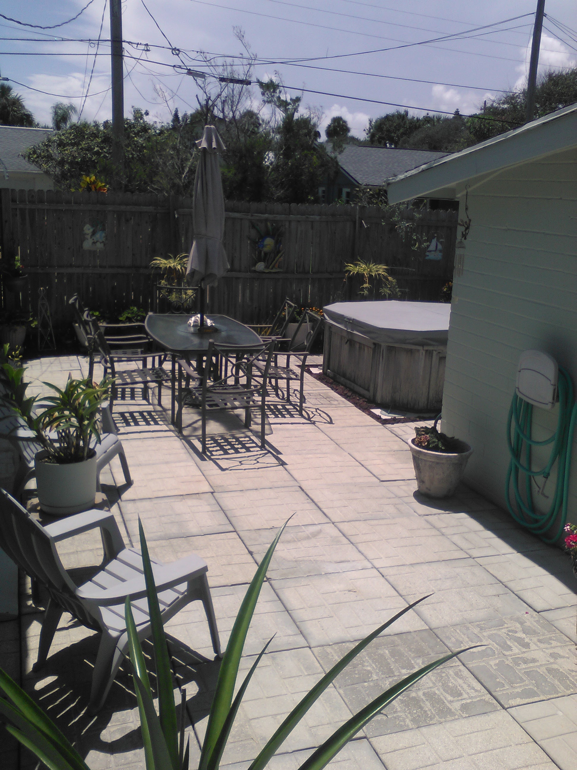 Patio with patio furniture and plants in the light of a partial eclipse.