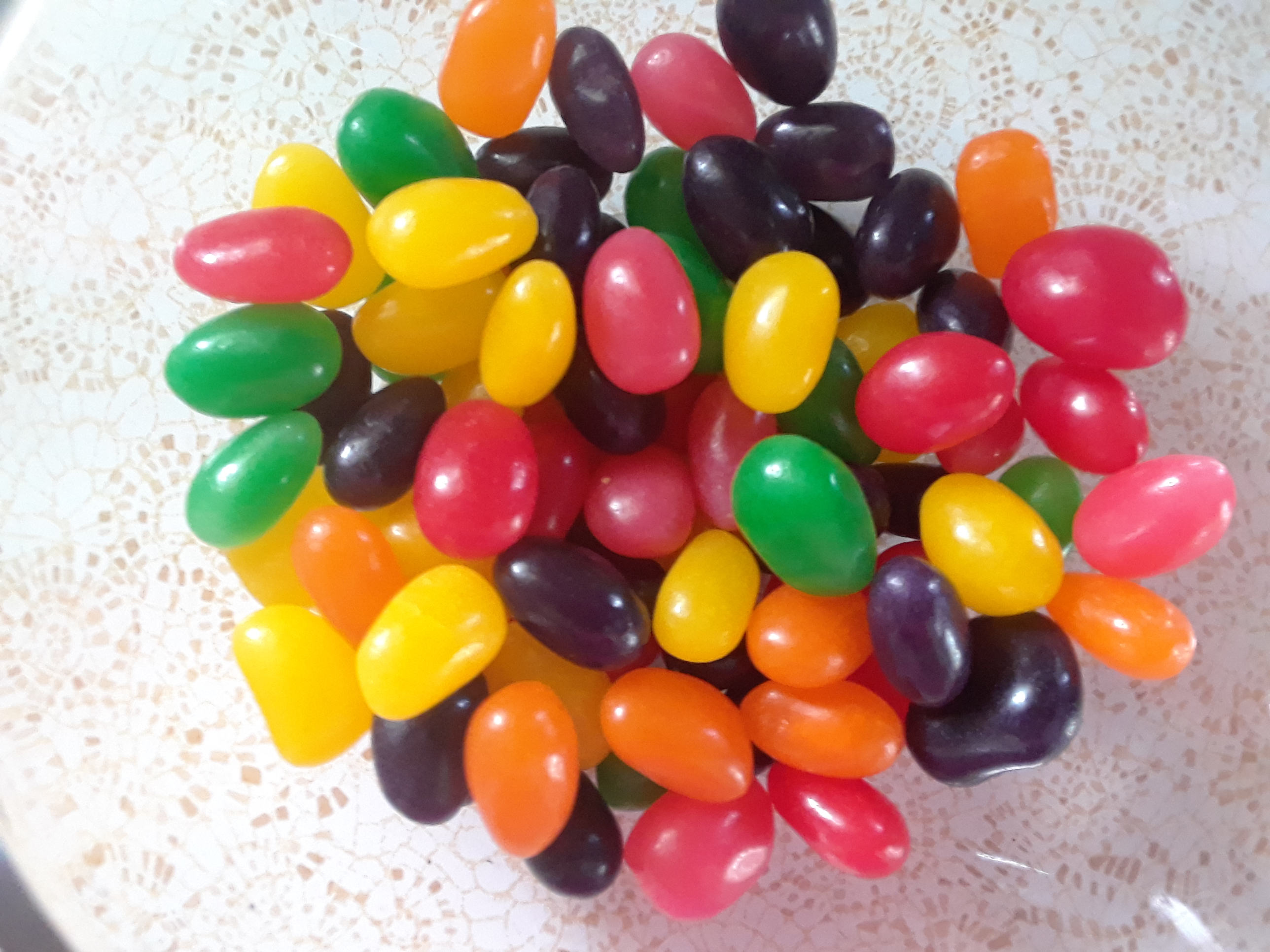 Jelly beans sitting on a plate.