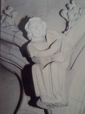 Medieval carving of minstrel playing harp in Beverley Minster.