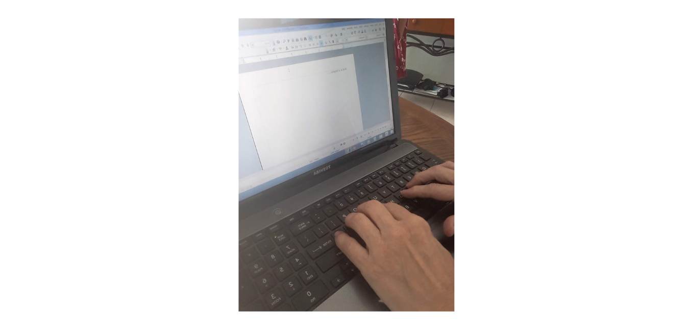 Hands typing on keyboard with blank screen.