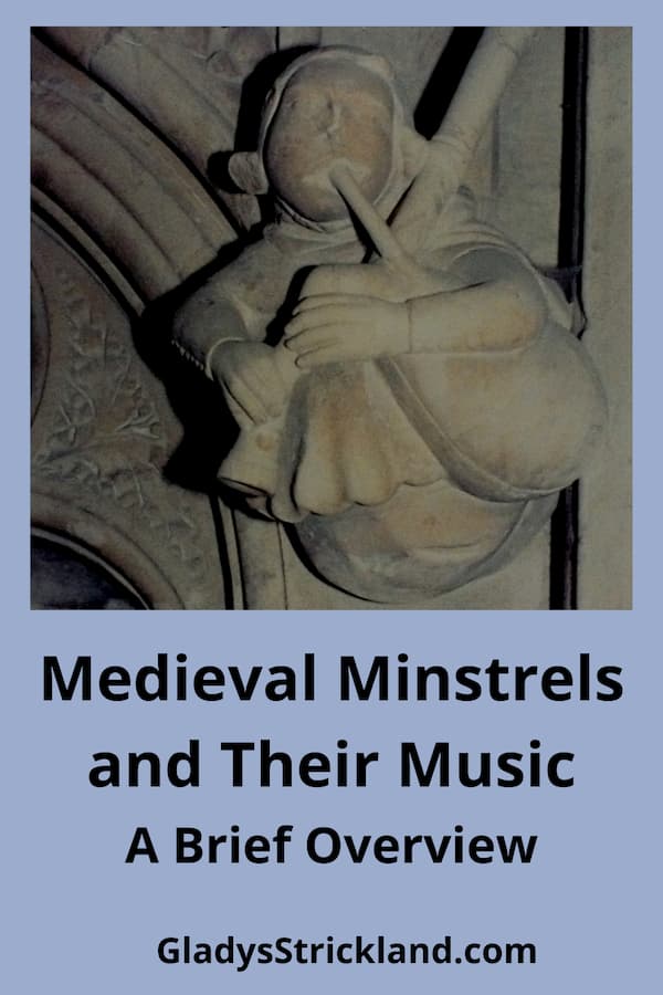 Carving of medieval minstrel playing bagpipes.
