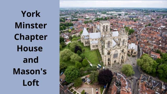 Aerial view of the exterior of York Minster from the west.  The twin west towers are seen, as is the tower of the central crossing and the roof of the chapter house. The building has green grass and trees around it, while in the distance are the buildings of the old part of York. 